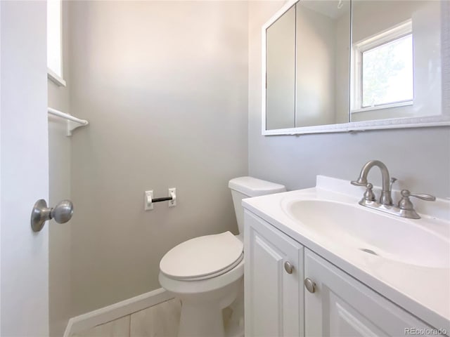 bathroom featuring vanity, tile patterned flooring, and toilet