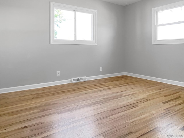 spare room with light hardwood / wood-style floors