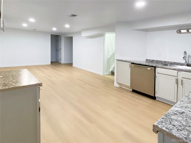 kitchen with light hardwood / wood-style floors, white cabinetry, dishwasher, and sink