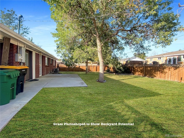 view of yard featuring a patio and central AC unit