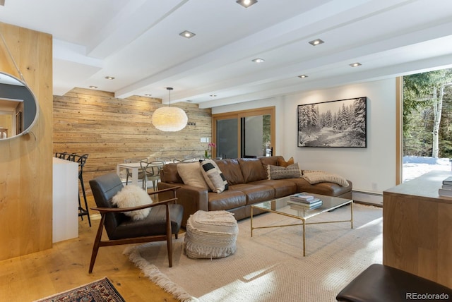 living room featuring light hardwood / wood-style flooring, wood walls, beam ceiling, and a baseboard heating unit