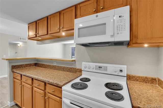 18034 E Ohio Ave Unit 104, Aurora, CO 80017 - kitchen featuring white appliances and brown cabinetry