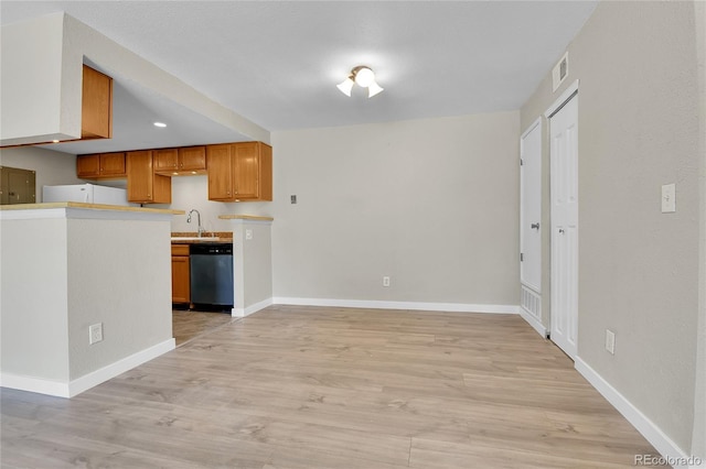 18034 E Ohio Ave Unit 104, Aurora, CO 80017 - kitchen featuring dishwasher, light wood finished floors, brown cabinetry, and light countertops