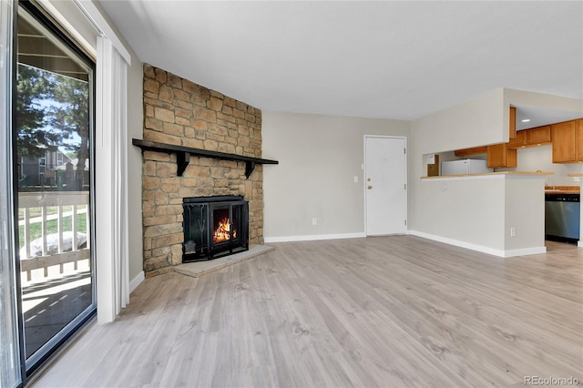 18034 E Ohio Ave Unit 104, Aurora, CO 80017 - unfurnished living room with light wood finished floors and a fireplace