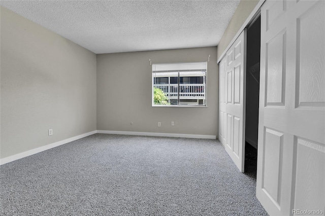 18034 E Ohio Ave Unit 104, Aurora, CO 80017 - unfurnished bedroom with carpet flooring, a textured ceiling, and a closet