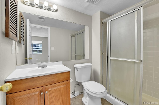 18034 E Ohio Ave Unit 104, Aurora, CO 80017 - bathroom featuring a shower stall, vanity, tile patterned floors, and a textured ceiling