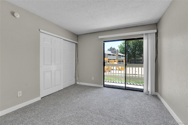 18034 E Ohio Ave Unit 104, Aurora, CO 80017 - unfurnished bedroom with access to exterior, a textured ceiling, carpet floors, and a closet