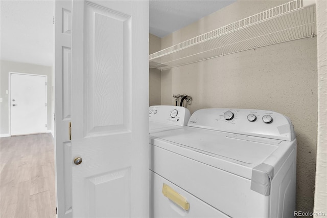 18034 E Ohio Ave Unit 104, Aurora, CO 80017 - washroom with wood finished floors and washer and dryer