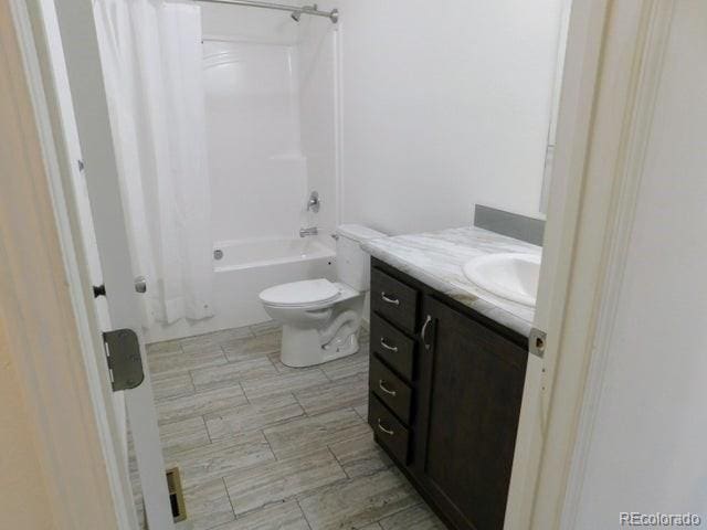 full bathroom with toilet, vanity, and shower / bathtub combination