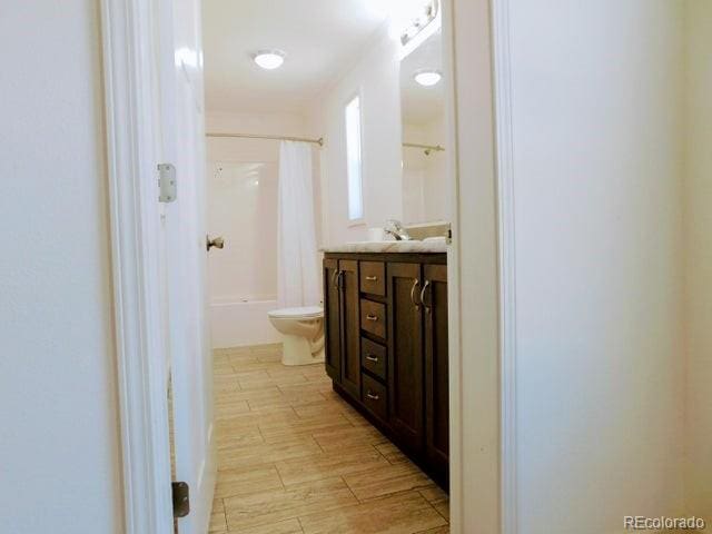 full bathroom featuring vanity, toilet, and shower / bath combination with curtain