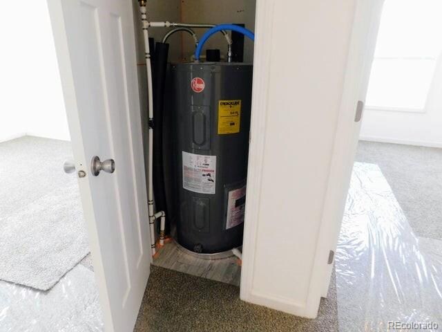 utility room featuring electric water heater