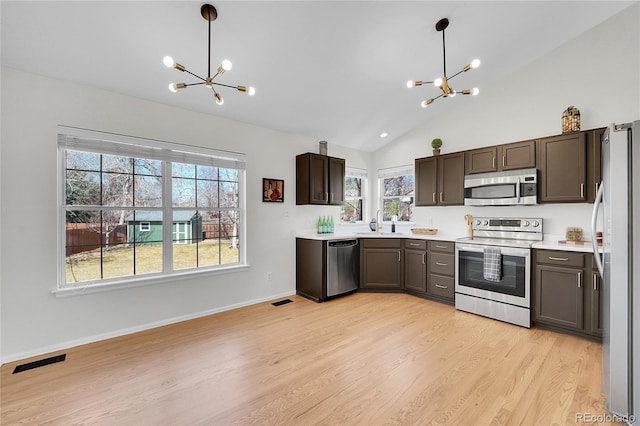 kitchen featuring a sink, visible vents, appliances with stainless steel finishes, and a chandelier