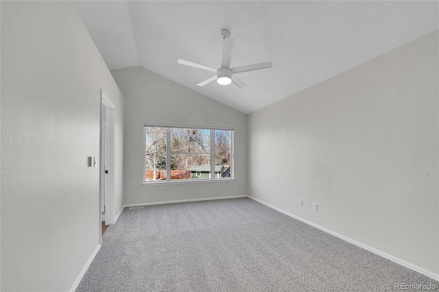 carpeted spare room with baseboards, lofted ceiling, and a ceiling fan