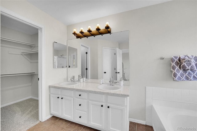 full bathroom featuring a sink, a walk in closet, a garden tub, and double vanity