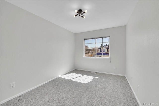 empty room featuring baseboards and carpet flooring