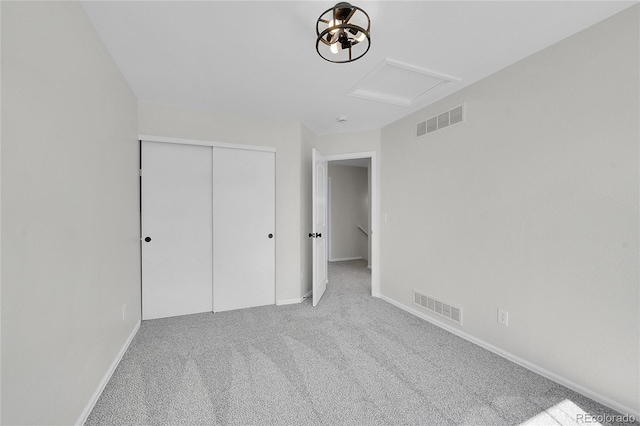 unfurnished bedroom with visible vents, baseboards, carpet, and a closet