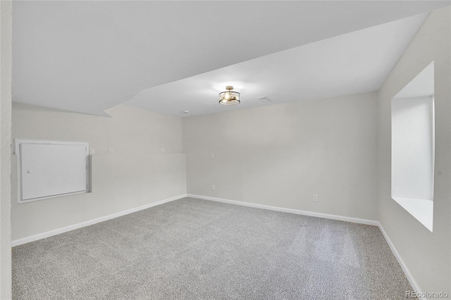 spare room with visible vents, baseboards, and carpet floors