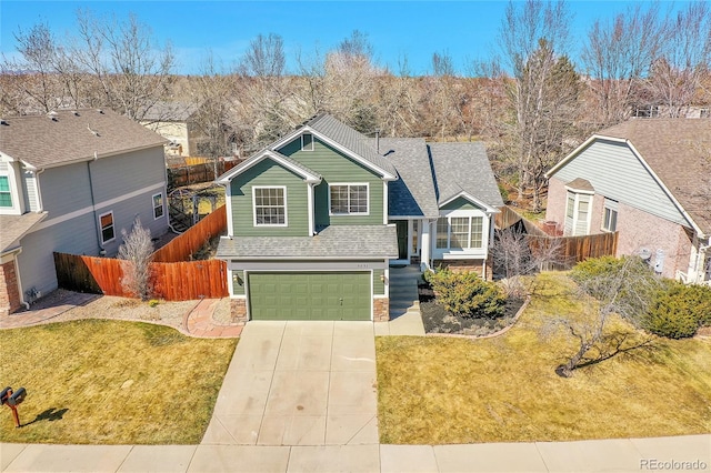 view of front of house with a front lawn, stone siding, fence, concrete driveway, and a garage