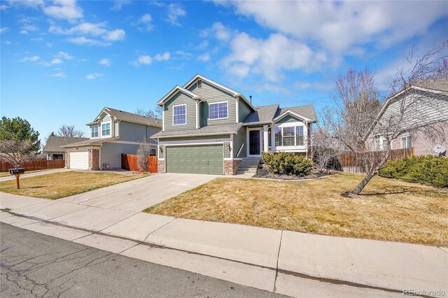 view of front of house featuring a front yard, concrete driveway, a garage, and fence