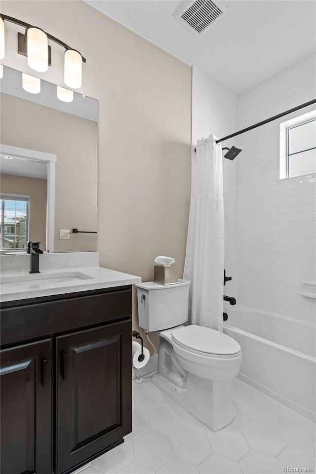 full bathroom with shower / bathtub combination with curtain, tile patterned flooring, vanity, and toilet