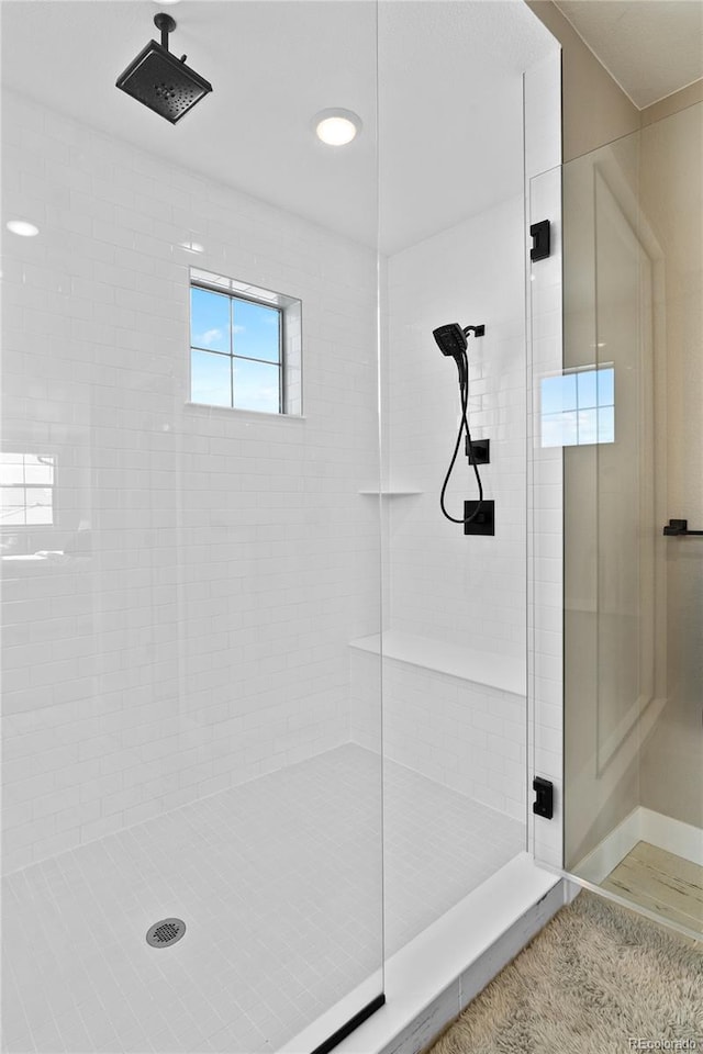 bathroom with a tile shower