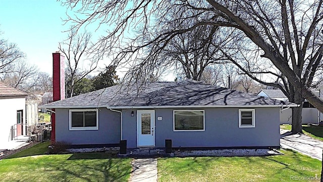 315 W 5th St, Julesburg, CO 80737 - ranch-style house with a chimney, stucco siding, and a front lawn