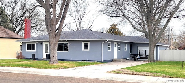 315 W 5th St, Julesburg, CO 80737 - single story home with entry steps, a chimney, fence, stucco siding, and a front lawn