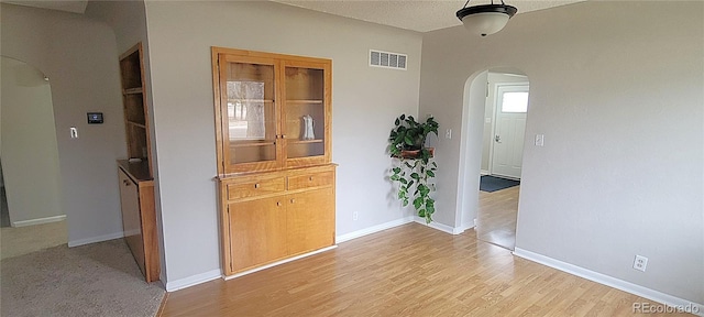 315 W 5th St, Julesburg, CO 80737 - interior space with visible vents, baseboards, light wood-type flooring, and arched walkways