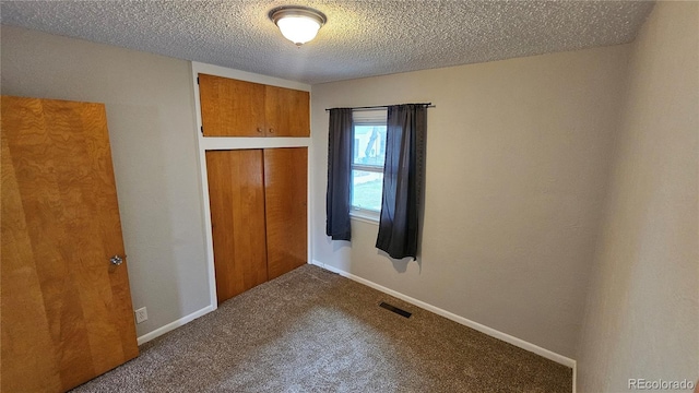 315 W 5th St, Julesburg, CO 80737 - unfurnished bedroom featuring a closet, baseboards, a textured ceiling, visible vents, and carpet