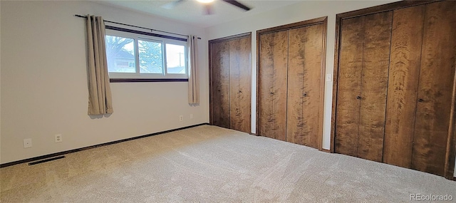 315 W 5th St, Julesburg, CO 80737 - unfurnished bedroom with light carpet, visible vents, two closets, and a ceiling fan
