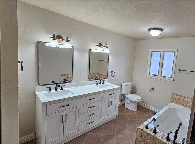 315 W 5th St, Julesburg, CO 80737 - bathroom with tile patterned floors, baseboards, a sink, and toilet