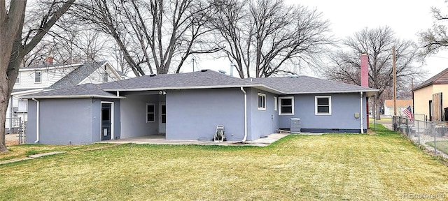 315 W 5th St, Julesburg, CO 80737 - back of property with central AC, a yard, stucco siding, a patio, and fence