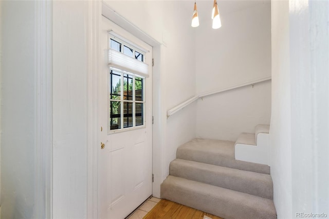 entryway featuring an inviting chandelier and light hardwood / wood-style flooring