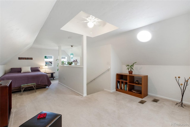 bedroom featuring ceiling fan, light colored carpet, and vaulted ceiling