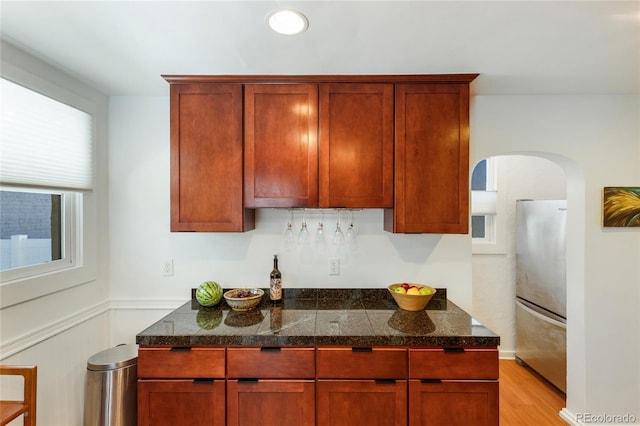 kitchen featuring stainless steel fridge and light wood-type flooring