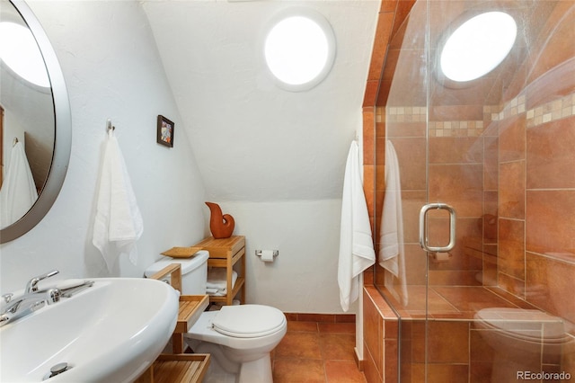 bathroom featuring sink, tile patterned flooring, lofted ceiling, toilet, and an enclosed shower