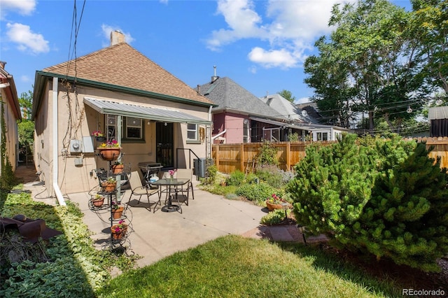 rear view of property with a patio area and central air condition unit