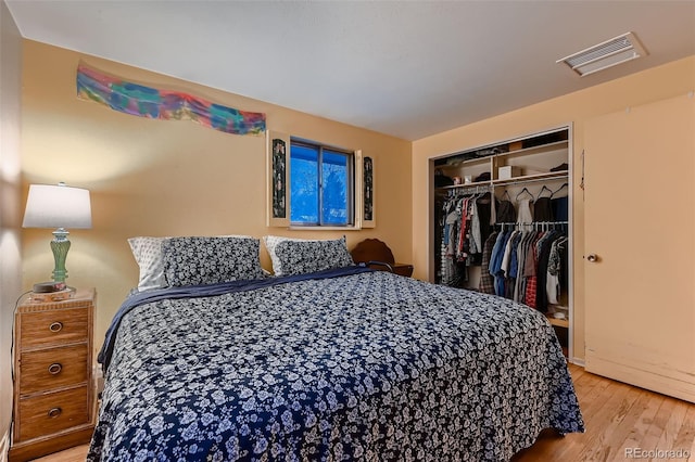 bedroom with light hardwood / wood-style flooring and a closet