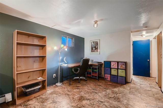 office area with baseboard heating, a textured ceiling, and built in features