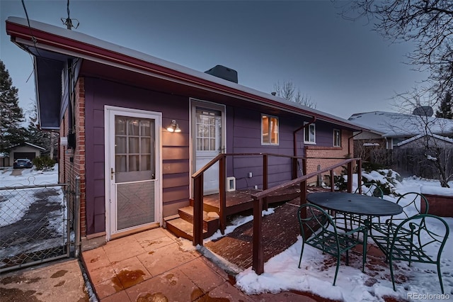 view of snow covered back of property