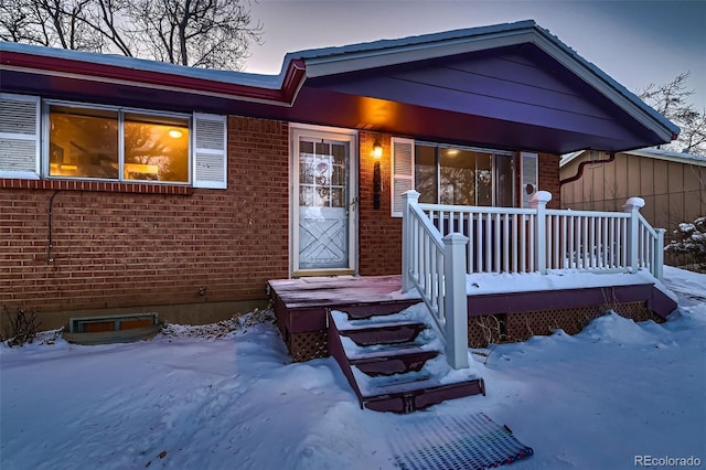 view of snow covered property entrance