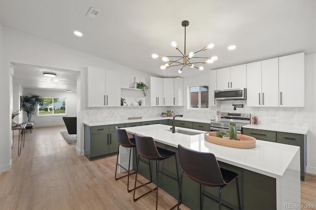 3025 Ivanhoe St, Denver, CO 80207 - kitchen with appliances with stainless steel finishes, open shelves, a chandelier, light countertops, and vaulted ceiling
