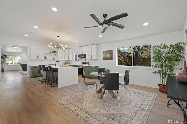 3025 Ivanhoe St, Denver, CO 80207 - dining area featuring a chandelier, recessed lighting, light wood-style flooring, and ceiling fan
