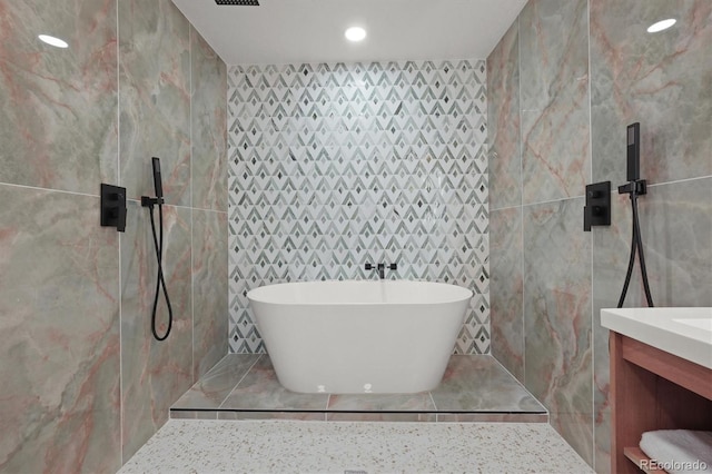3025 Ivanhoe St, Denver, CO 80207 - full bath featuring tile walls, a soaking tub, vanity, and recessed lighting