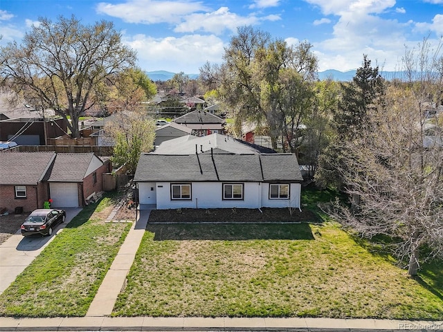 3025 Ivanhoe St, Denver, CO 80207 - view of front of home featuring a mountain view, a front lawn, concrete driveway, and a shingled roof