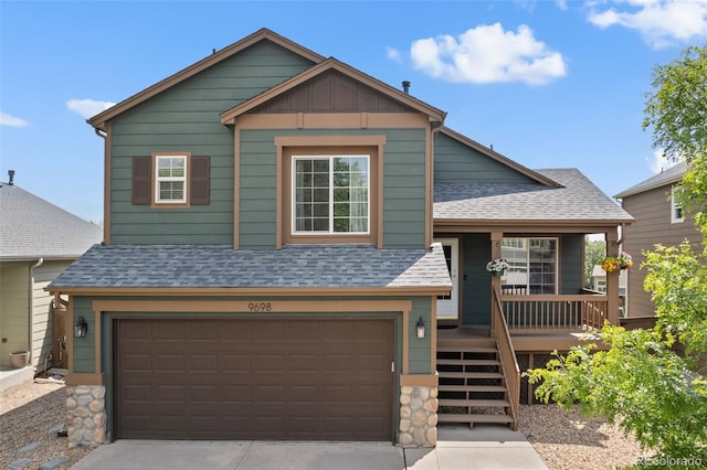 9698 Queenscliffe Dr, Highlands Ranch, CO 80130 - view of front of house with roof with shingles, a garage, board and batten siding, and driveway