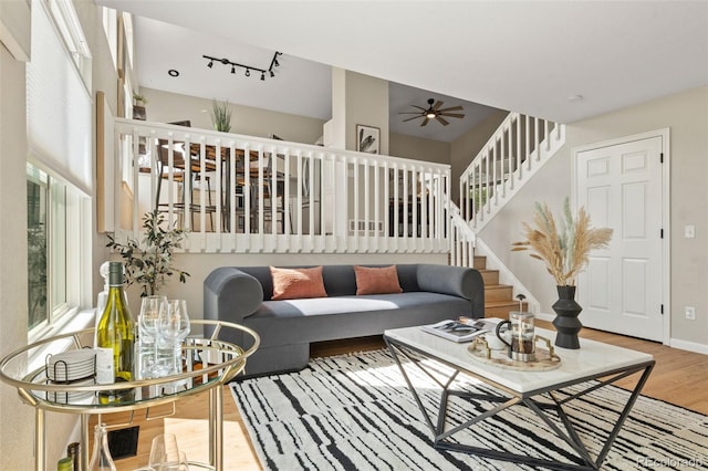 9698 Queenscliffe Dr, Highlands Ranch, CO 80130 - living area featuring wood finished floors, stairway, ceiling fan, and baseboards