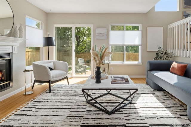 9698 Queenscliffe Dr, Highlands Ranch, CO 80130 - living room featuring plenty of natural light, wood finished floors, and baseboards