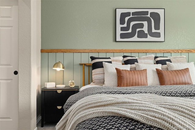 9698 Queenscliffe Dr, Highlands Ranch, CO 80130 - bedroom featuring a textured wall, a decorative wall, and a wainscoted wall