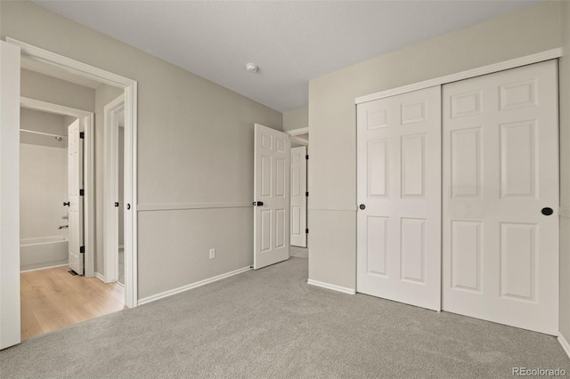 9698 Queenscliffe Dr, Highlands Ranch, CO 80130 - unfurnished bedroom with carpet, a closet, baseboards, and connected bathroom